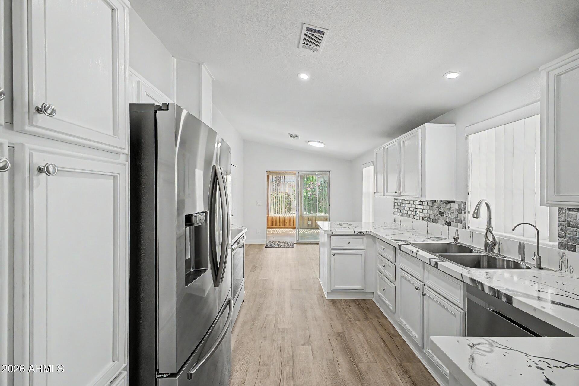 2550 South Ellsworth Road, Unit 50 Mesa, AZ 85209 - Photo 7 of 45 a large kitchen with a sink stainless steel appliances and cabinets