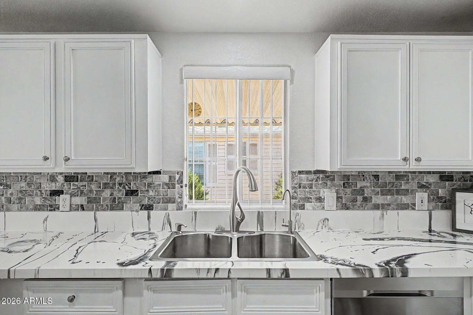 2550 South Ellsworth Road, Unit 50 Mesa, AZ 85209 - Photo 8 of 45 a kitchen with a sink and white cabinets