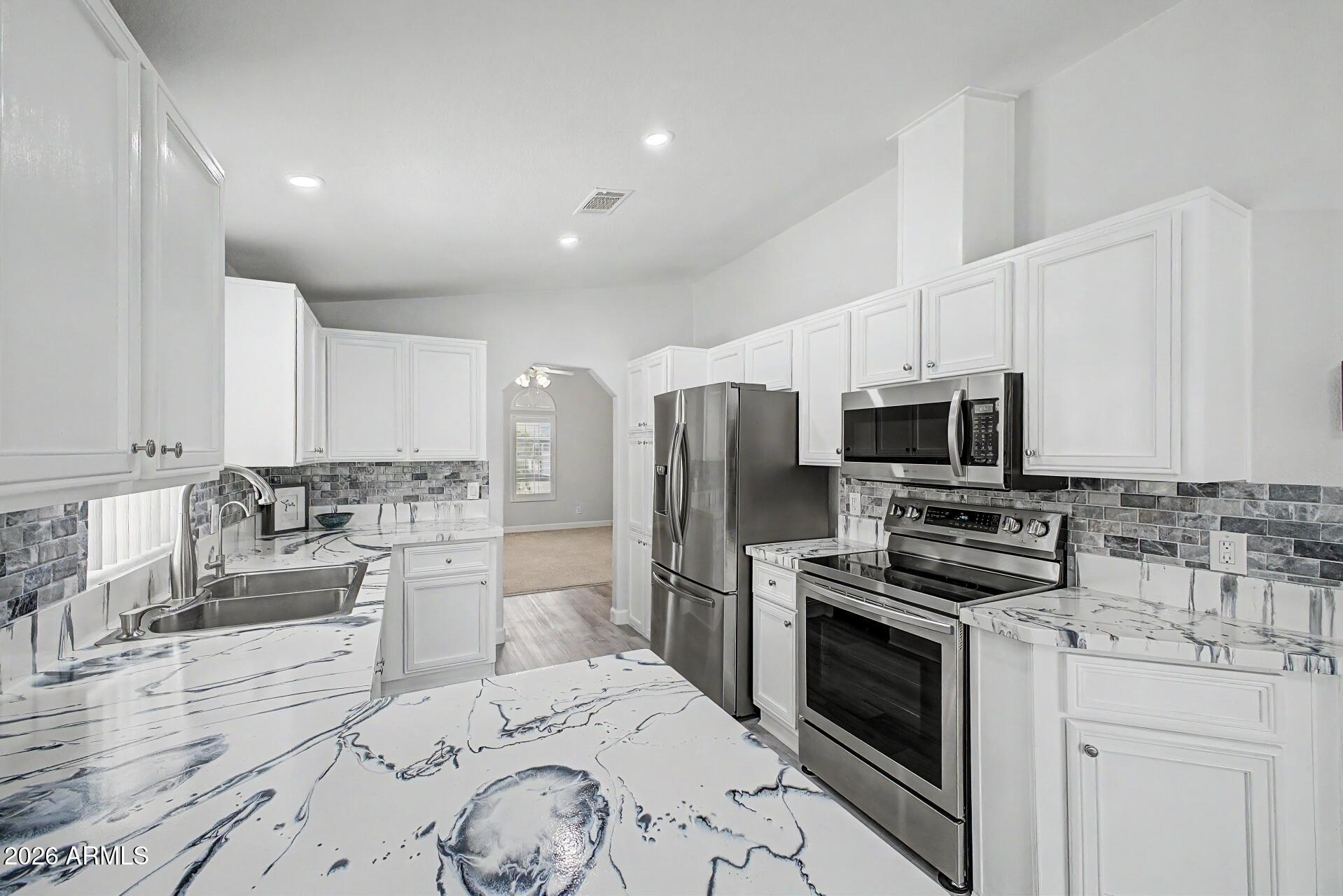 2550 South Ellsworth Road, Unit 50 Mesa, AZ 85209 - Photo 9 of 45 a kitchen with a sink stove and refrigerator