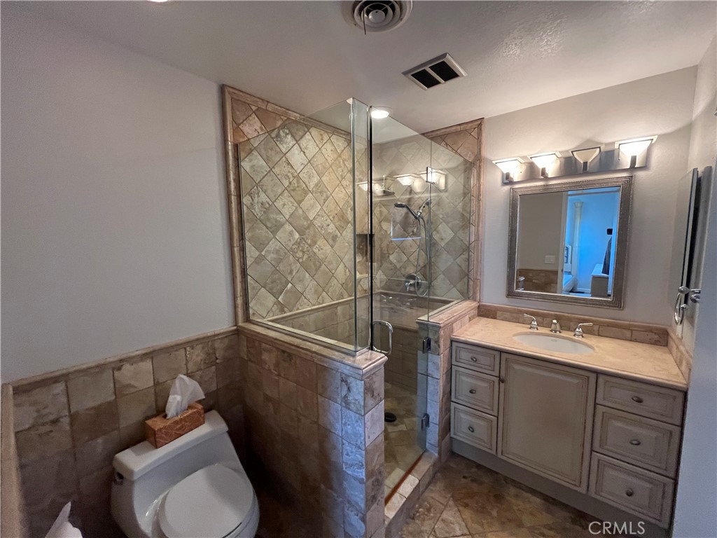 4811 Cathy Avenue Cypress, CA 90630 - Photo 14 of 23 a bathroom with a toilet sink and mirror
