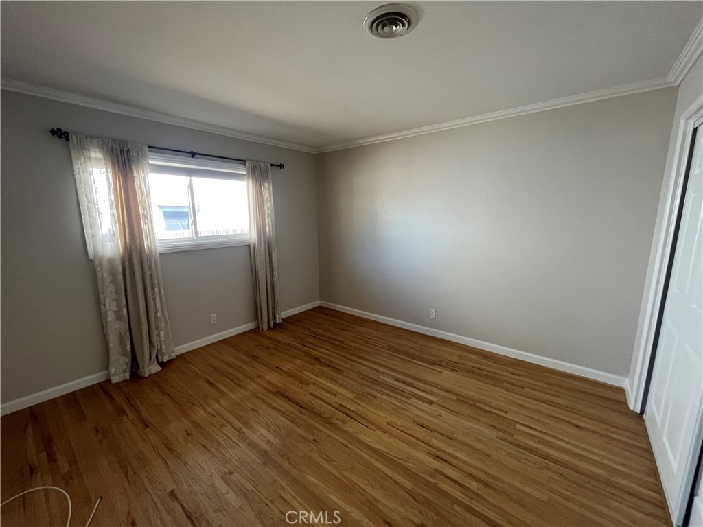 4811 Cathy Avenue Cypress, CA 90630 - Photo 15 of 23 an empty room with wooden floor and windows