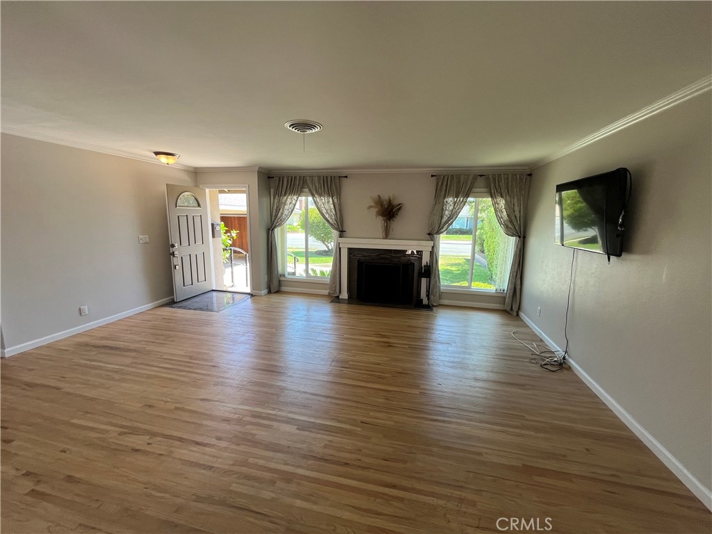 4811 Cathy Avenue Cypress, CA 90630 - Photo 3 of 23 an empty room with wooden floor and a fireplace