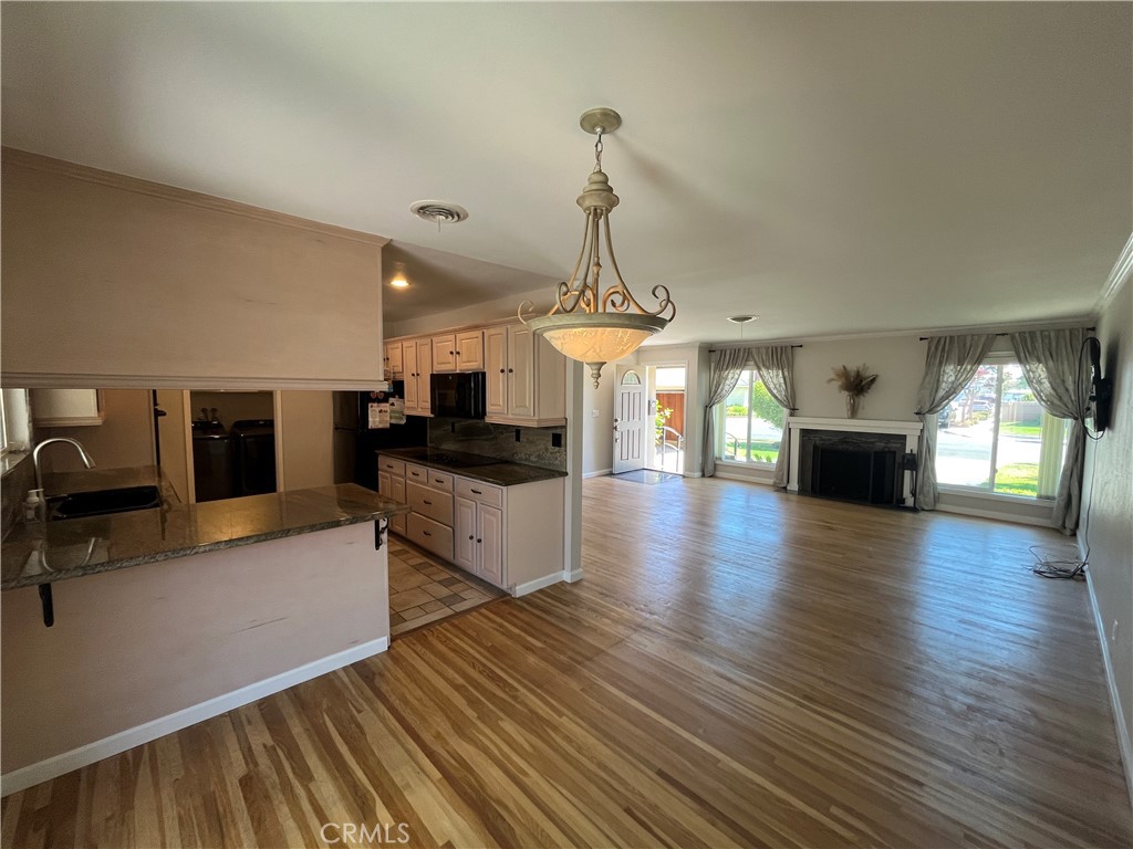 4811 Cathy Avenue Cypress, CA 90630 - Photo 6 of 23 a view of a living room and kitchen with furniture wooden floor