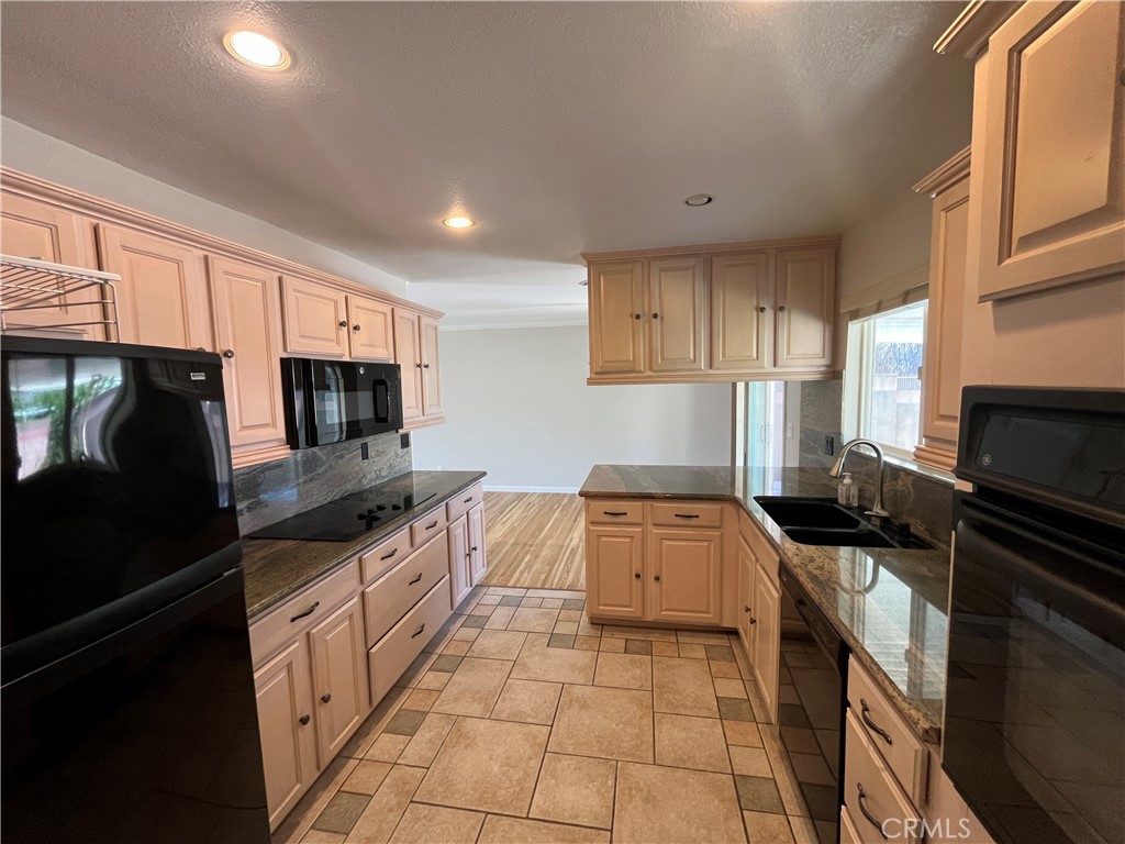 4811 Cathy Avenue Cypress, CA 90630 - Photo 7 of 23 a kitchen with granite countertop a stove sink and cabinets
