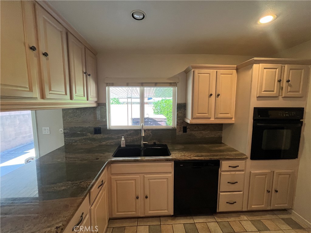 4811 Cathy Avenue Cypress, CA 90630 - Photo 9 of 23 a kitchen with granite countertop a sink stove and cabinets