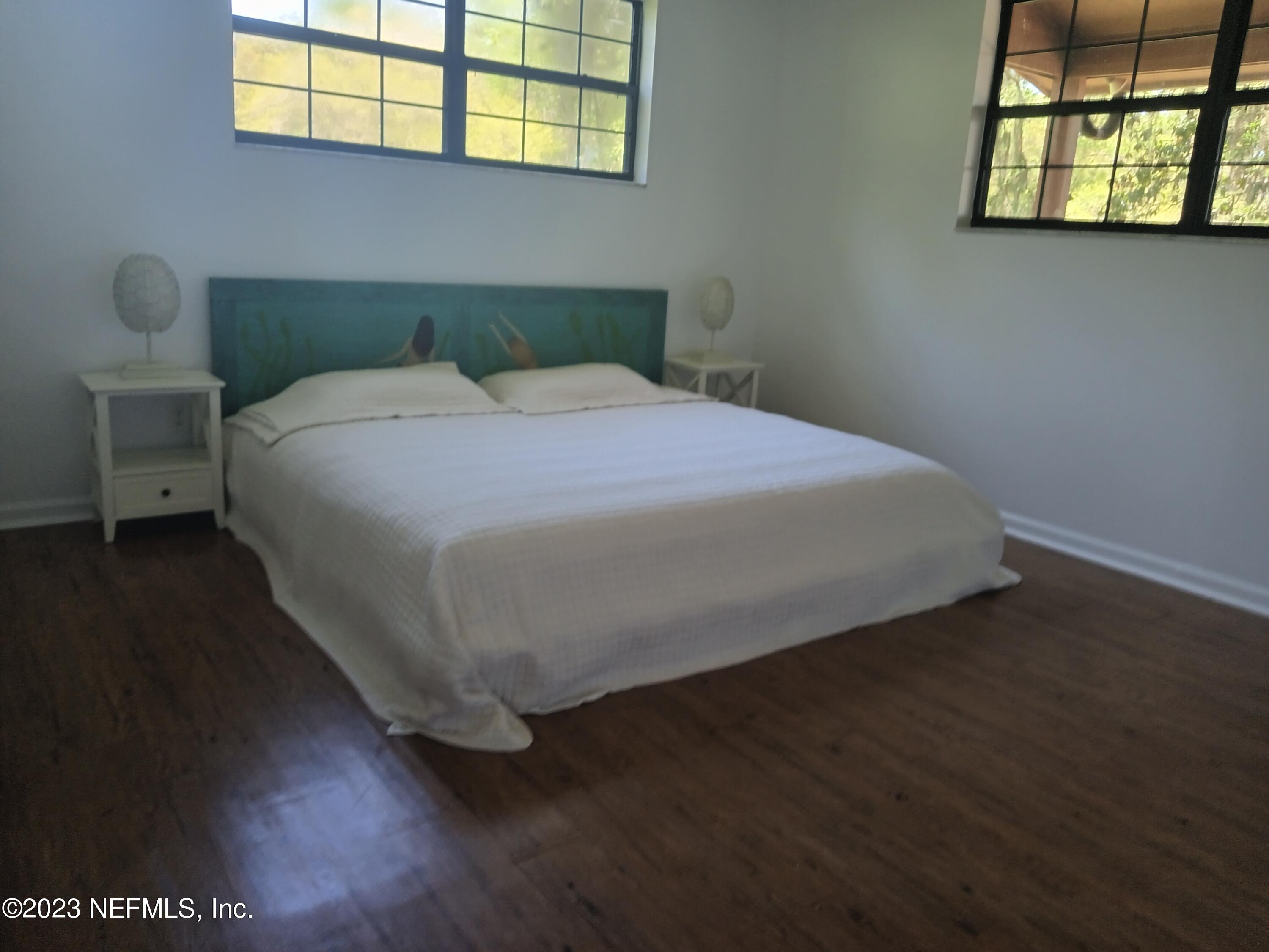 97612 Pirates Point Road Yulee, FL 32097 - Photo 14 of 23 a bedroom with a bed and a window