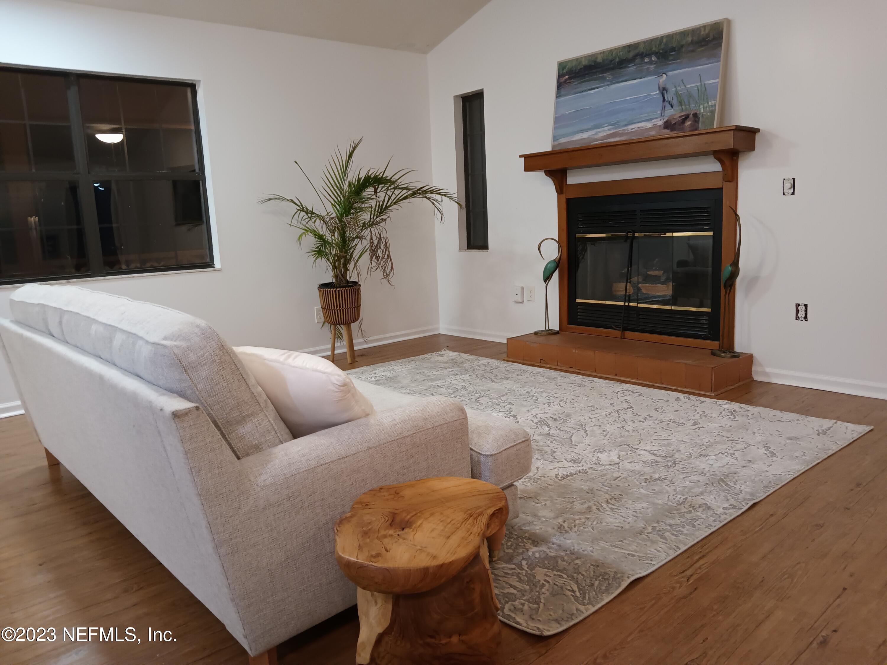 97612 Pirates Point Road Yulee, FL 32097 - Photo 20 of 23 a living room with furniture and a fireplace
