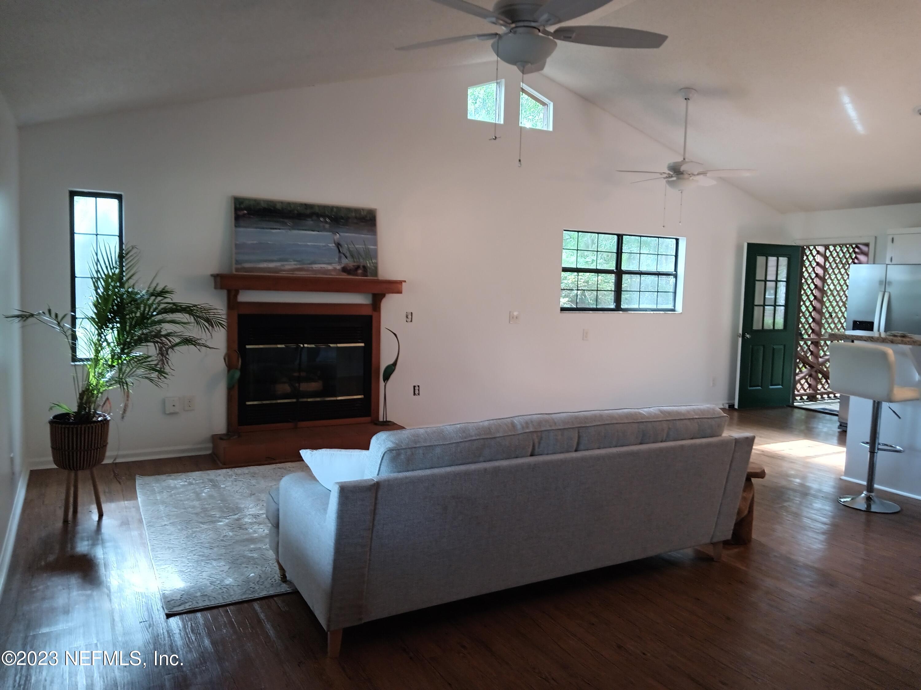 97612 Pirates Point Road Yulee, FL 32097 - Photo 22 of 23 a living room with furniture and a fireplace