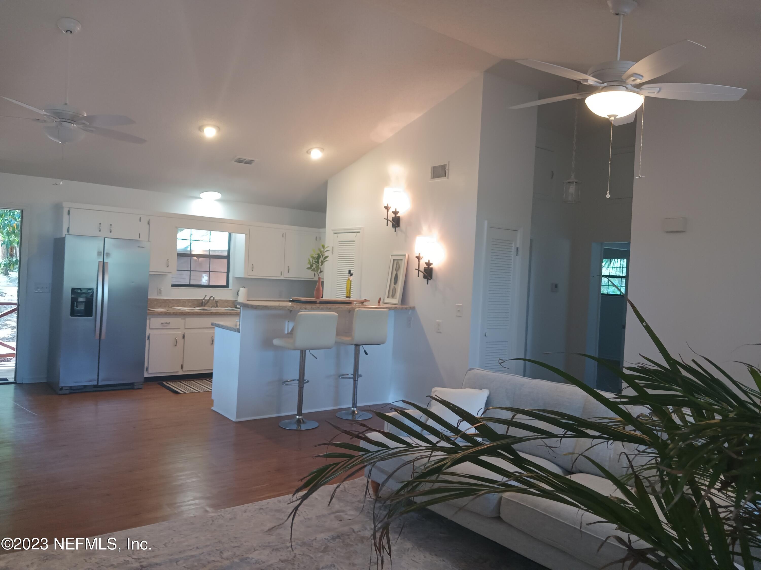 97612 Pirates Point Road Yulee, FL 32097 - Photo 3 of 23 a kitchen with a refrigerator and a sink