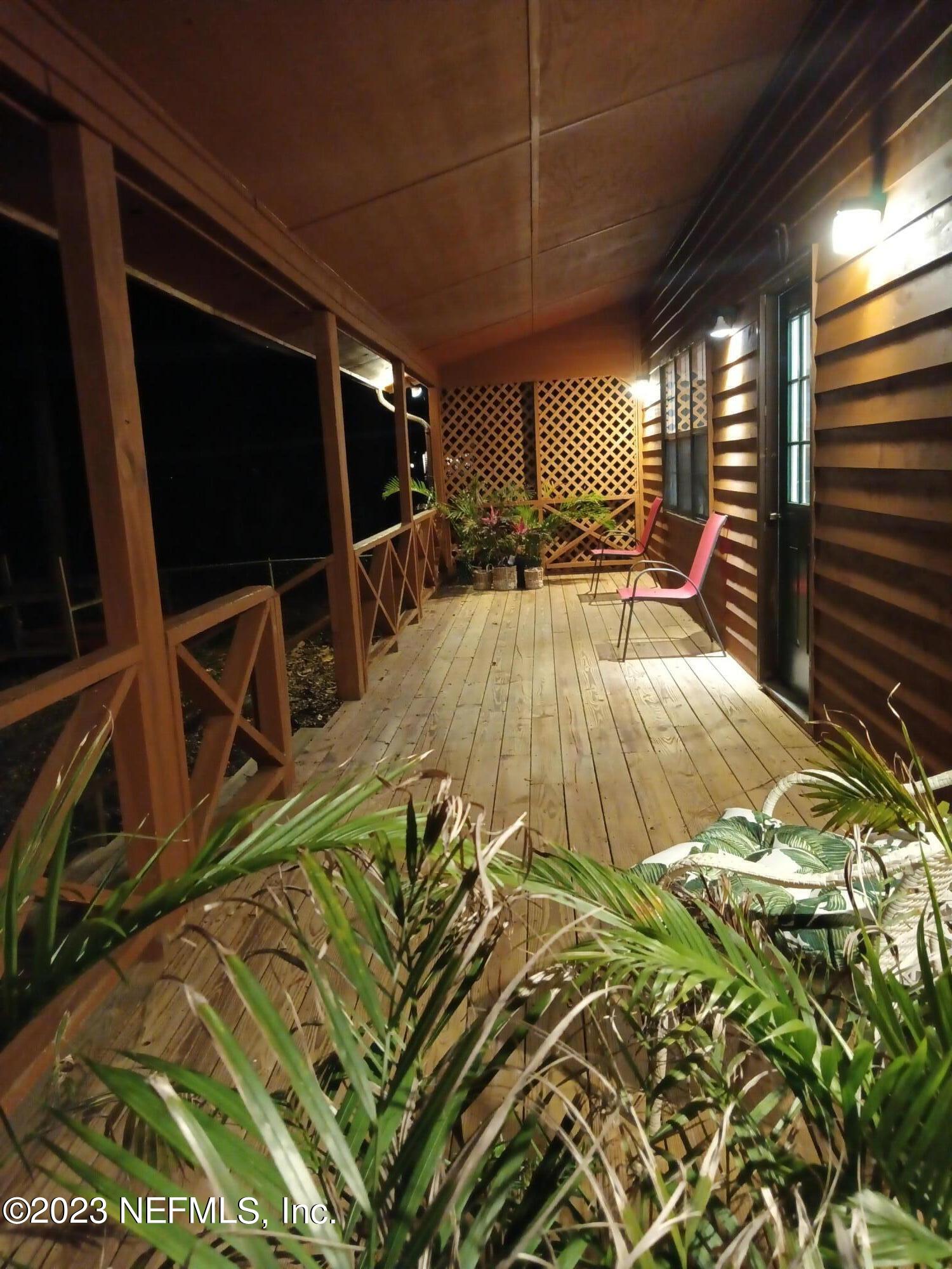 97612 Pirates Point Road Yulee, FL 32097 - Photo 4 of 23 a view of a swimming pool with a patio and a yard