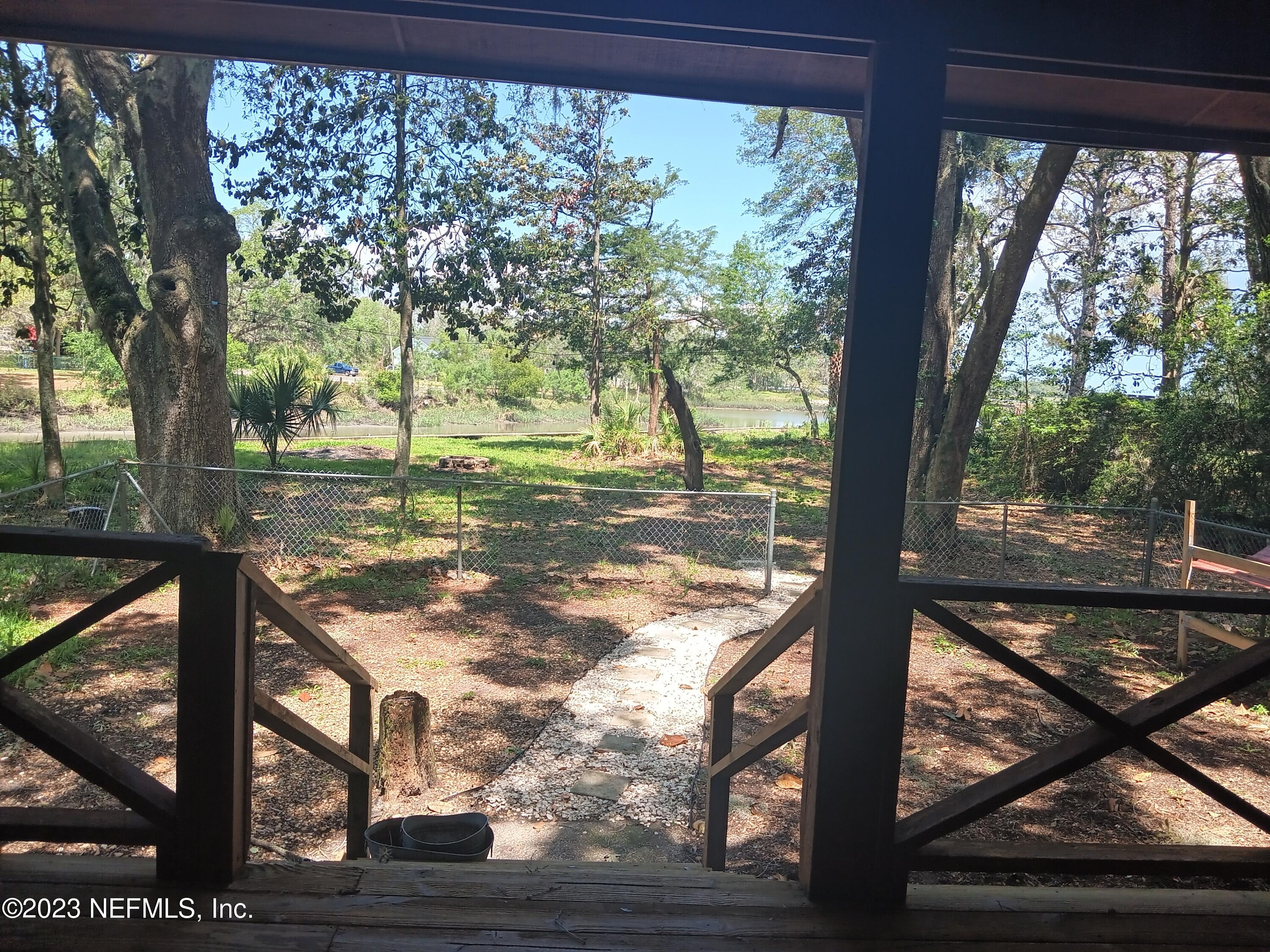 97612 Pirates Point Road Yulee, FL 32097 - Photo 5 of 23 a view of backyard with tree