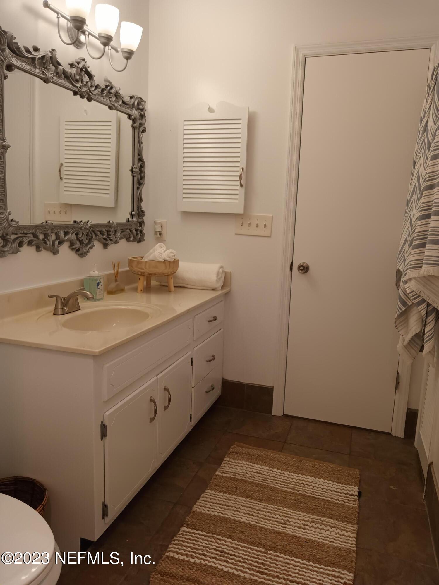 97612 Pirates Point Road Yulee, FL 32097 - Photo 7 of 23 a bathroom with a sink and a mirror