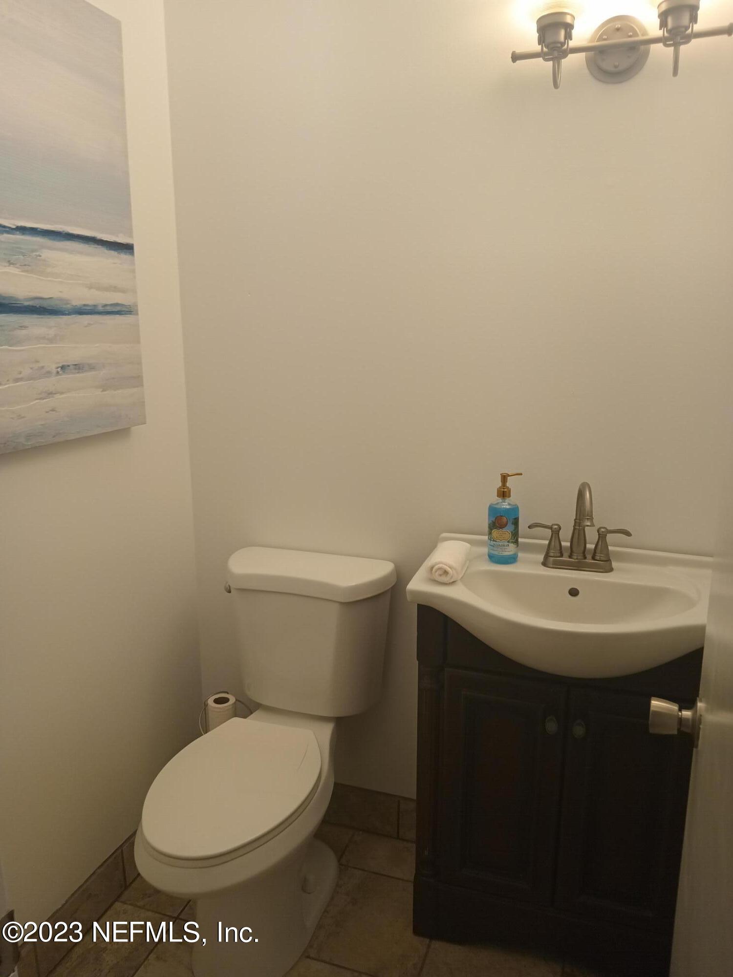 97612 Pirates Point Road Yulee, FL 32097 - Photo 8 of 23 a bathroom with a toilet a sink and mirror