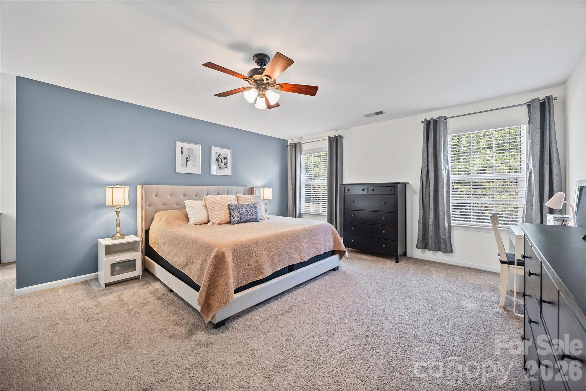 4470 Haddington Drive Indian Land, SC 29707 - Photo 14 of 27 a bedroom with a bed and a chandelier