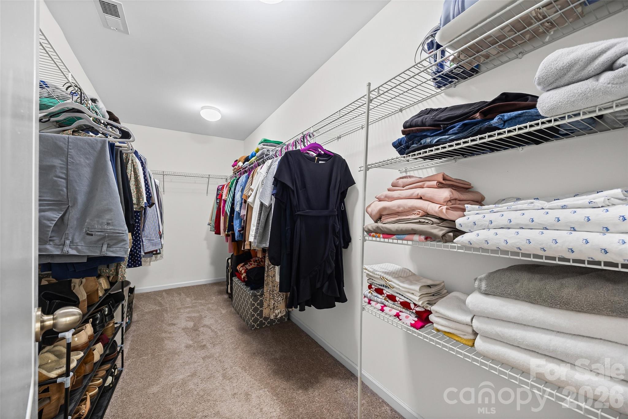4470 Haddington Drive Indian Land, SC 29707 - Photo 15 of 27 a view of walk in closet with clothes and shoes