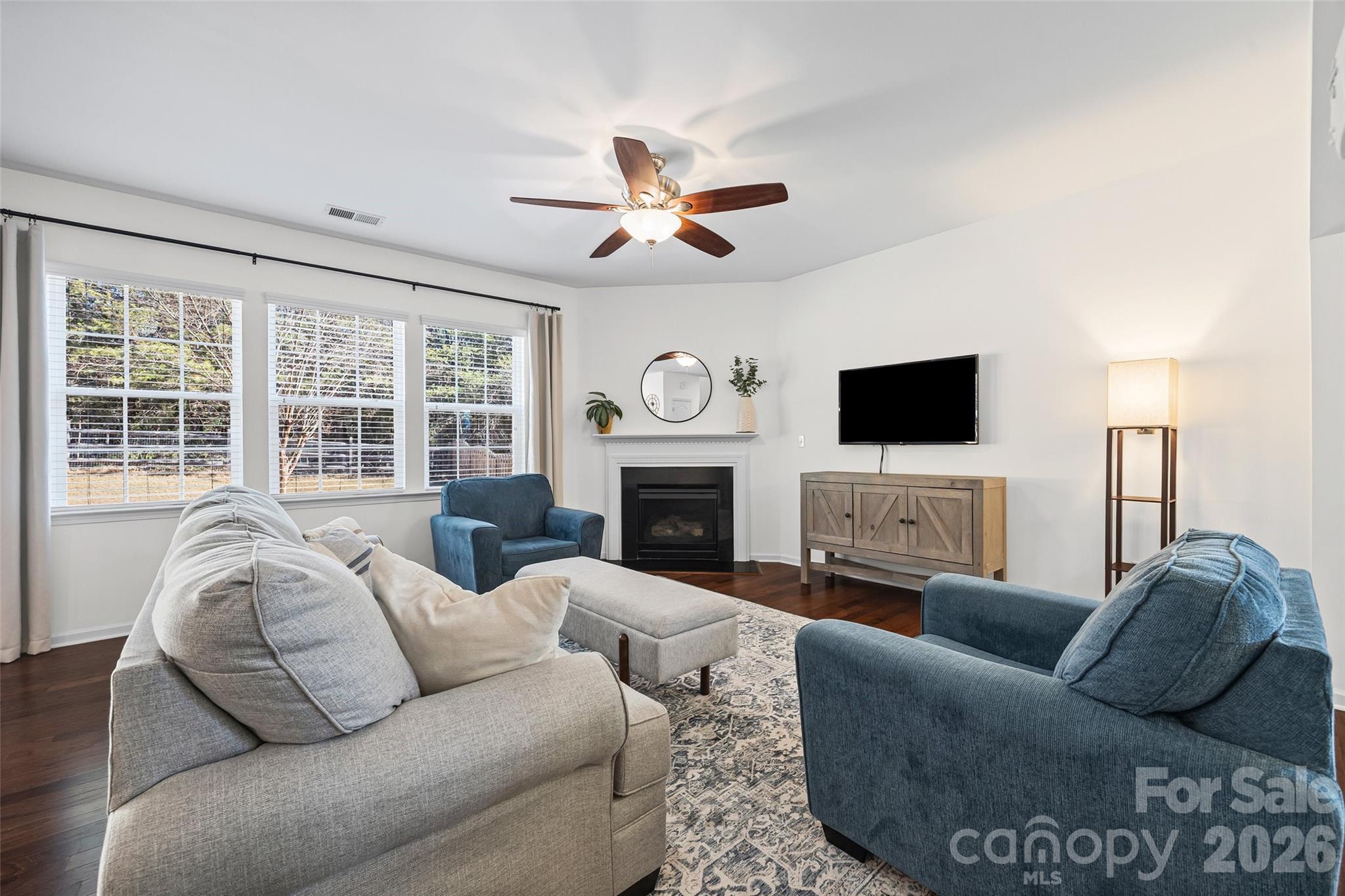 4470 Haddington Drive Indian Land, SC 29707 - Photo 8 of 27 a living room with furniture a fireplace and a flat screen tv