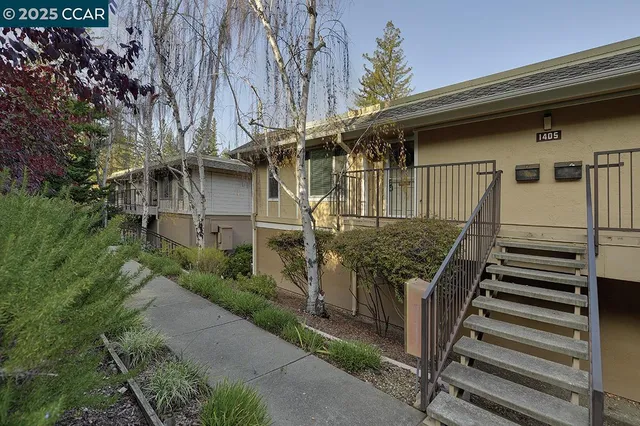 a view of a house with wooden fence