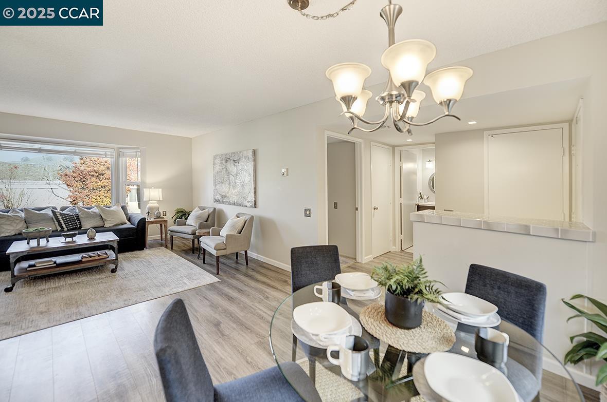 1405 Ptarmigan Drive, Unit 1 Walnut Creek, CA 94595 - Photo 15 of 39 a living room with furniture chandelier and a chandelier