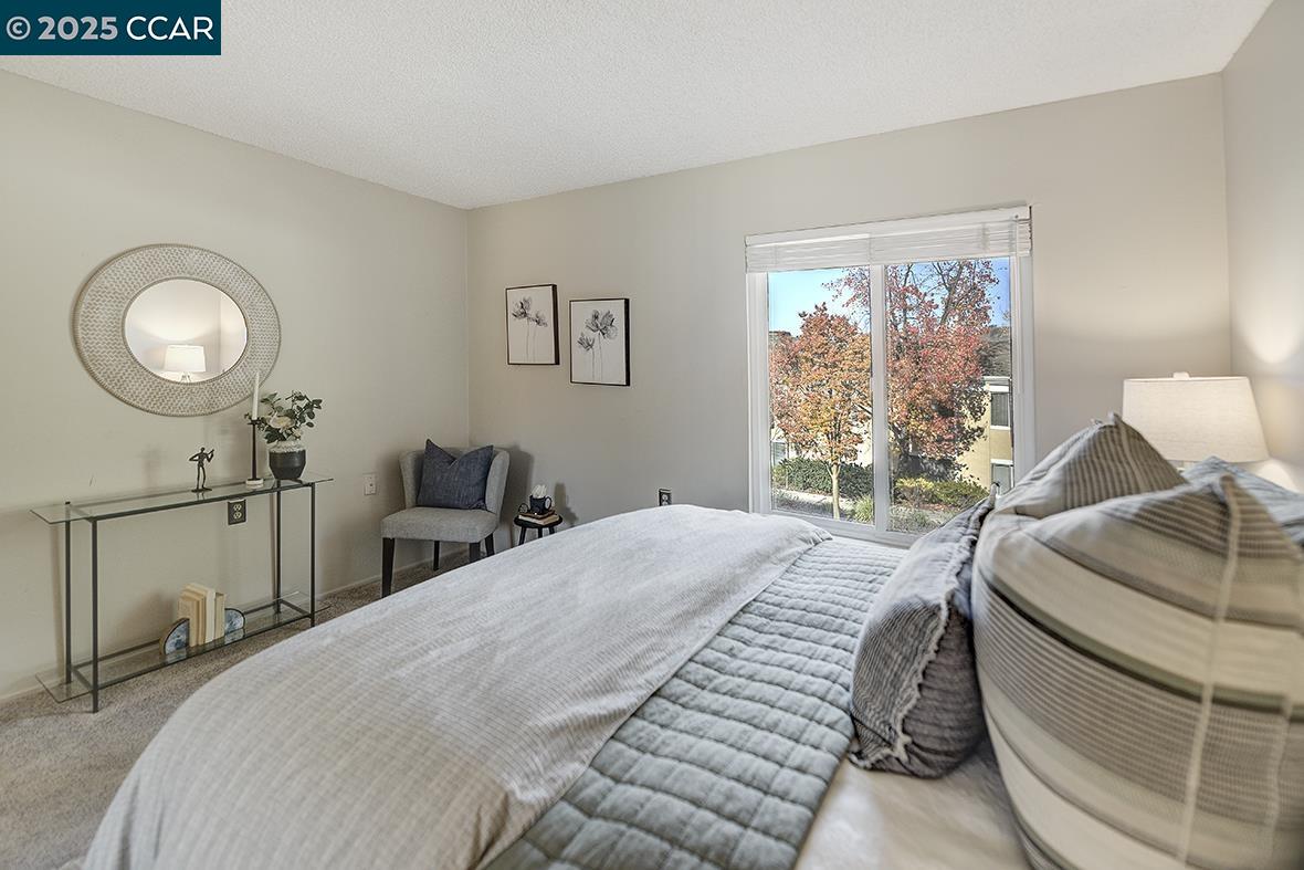 1405 Ptarmigan Drive, Unit 1 Walnut Creek, CA 94595 - Photo 17 of 39 a bedroom with a bed and window