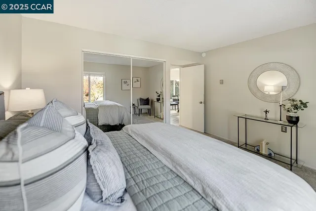 a bedroom with a bed and glass door