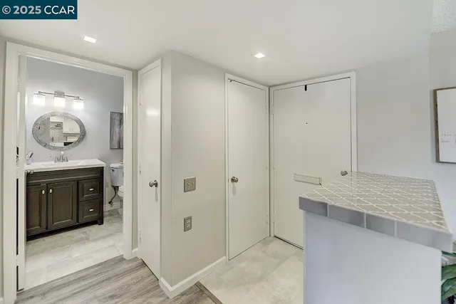 a bathroom with a sink a toilet and a mirror