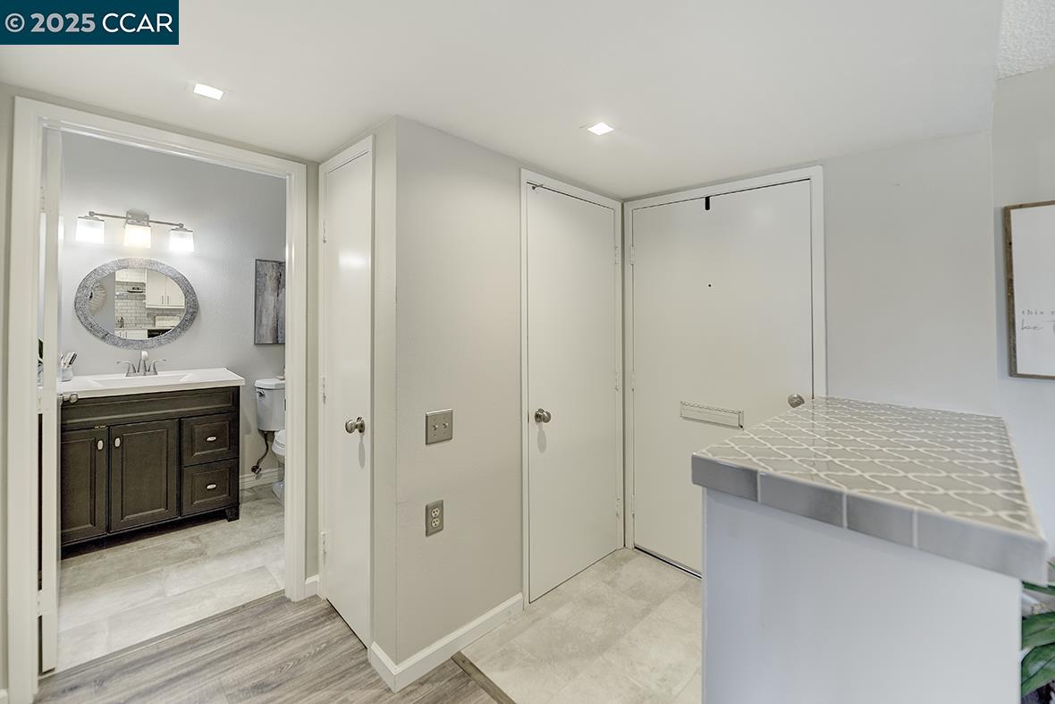 1405 Ptarmigan Drive, Unit 1 Walnut Creek, CA 94595 - Photo 20 of 39 a bathroom with a double vanity sink and mirror