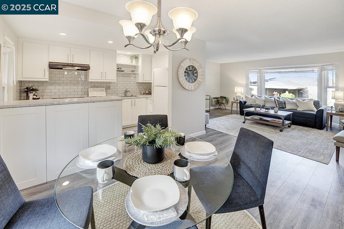 1405 Ptarmigan Drive, Unit 1 Walnut Creek, CA 94595 - Photo 8 of 39 a view of a dining room with furniture a chandelier and wooden floor