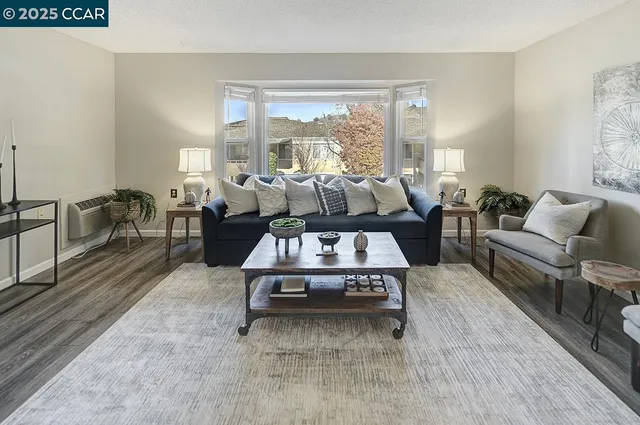 a living room with furniture and a large window