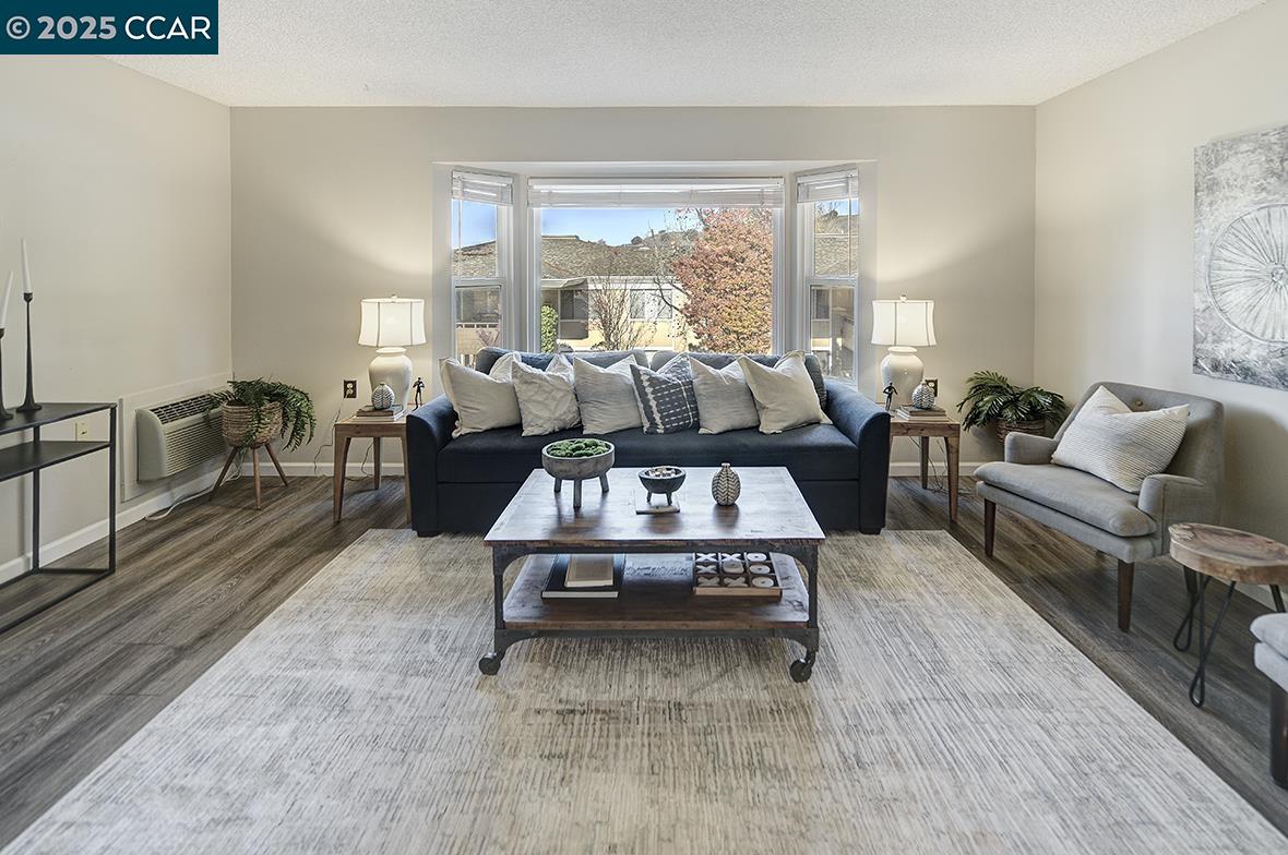 1405 Ptarmigan Drive, Unit 1 Walnut Creek, CA 94595 - Photo 9 of 39 a living room with furniture and a large window