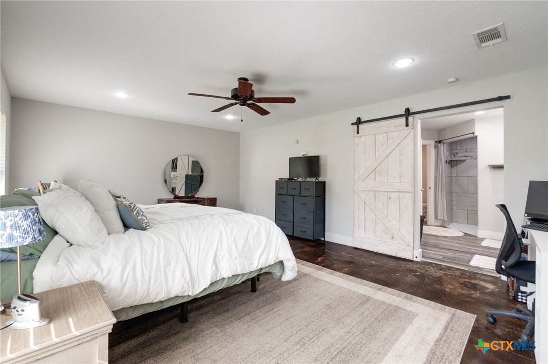 469 Whispering Oaks Loop Killeen, TX 76549 - Photo 15 of 48 a bedroom with a bed and a view of kitchen