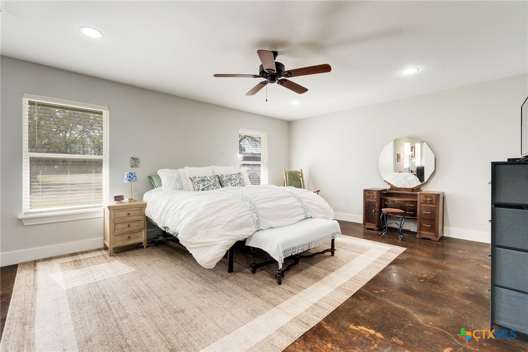 469 Whispering Oaks Loop Killeen, TX 76549 - Photo 16 of 48 a bedroom with a bed large window and a chandelier