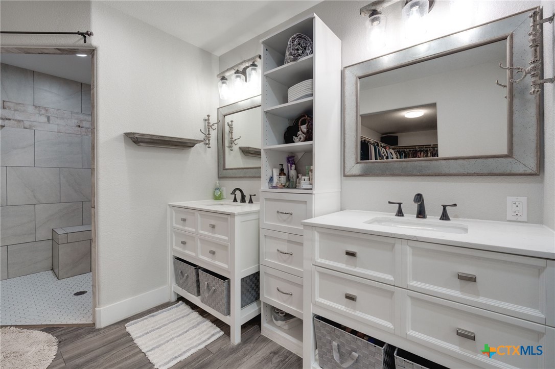 469 Whispering Oaks Loop Killeen, TX 76549 - Photo 18 of 48 a bathroom with a double vanity sink a mirror and shower
