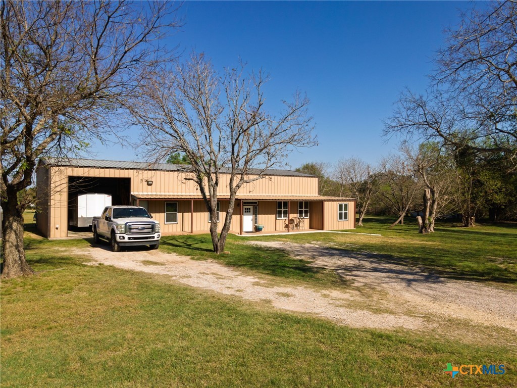 469 Whispering Oaks Loop Killeen, TX 76549 - Photo 2 of 48 a car parked in front of a brick house next to a yard