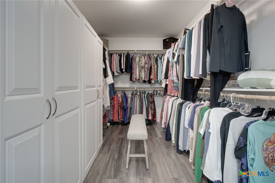 469 Whispering Oaks Loop Killeen, TX 76549 - Photo 21 of 48 a view of walk in closet with clothes and shoes