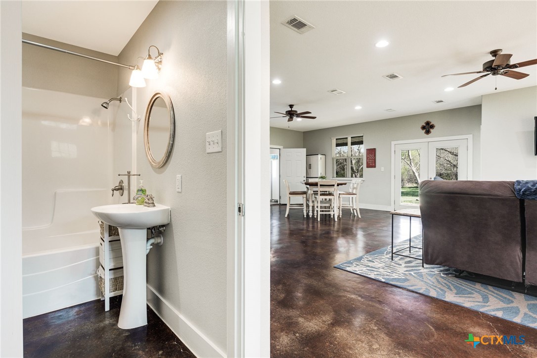469 Whispering Oaks Loop Killeen, TX 76549 - Photo 22 of 48 a en suite bathroom with a sink and a mirror
