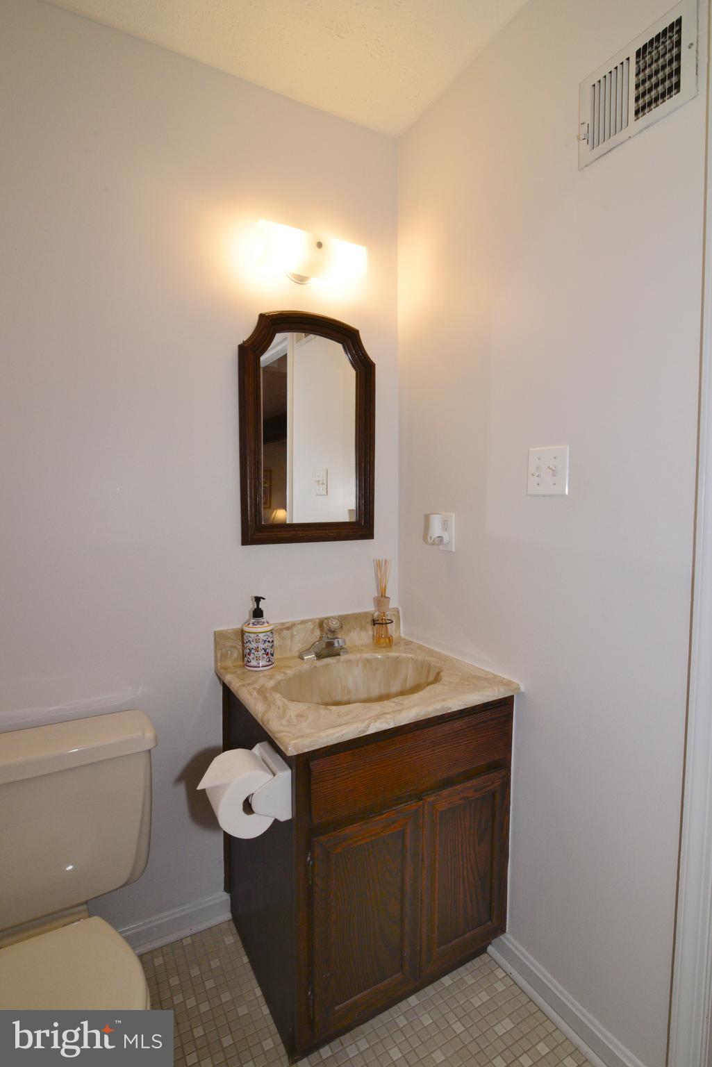 1966 Barton Hill Road Reston, VA 20191 - Photo 35 of 52 a bathroom with a toilet sink and mirror
