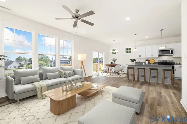 a living room with furniture and kitchen view