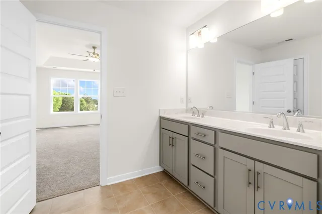 a bathroom with a double vanity sink and a mirror