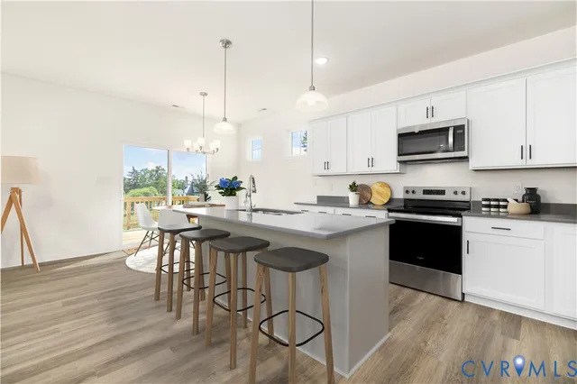 a kitchen with a table chairs stove and cabinets