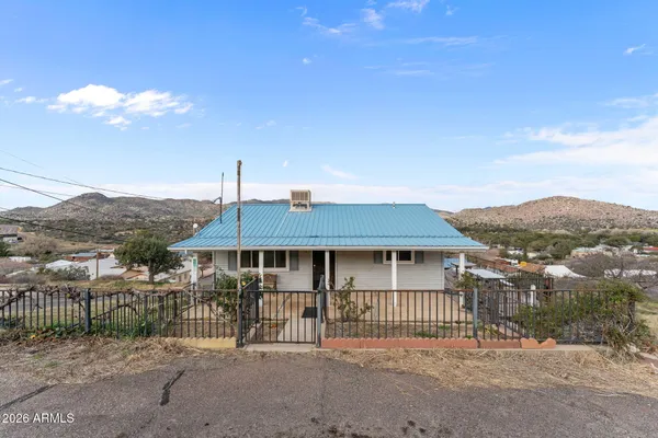 a view of a house with a iron gate