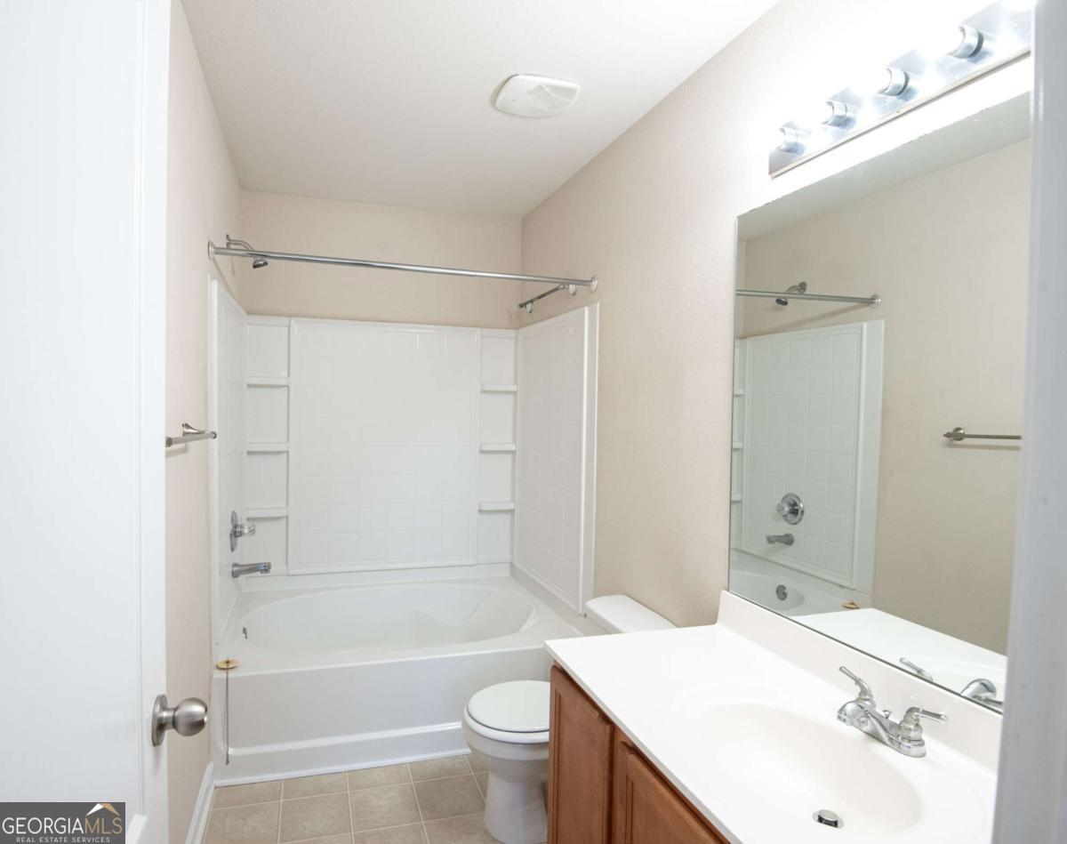 1259 Chinon Point Lithonia, GA 30058 - Photo 19 of 27 a bathroom with a sink a toilet and shower
