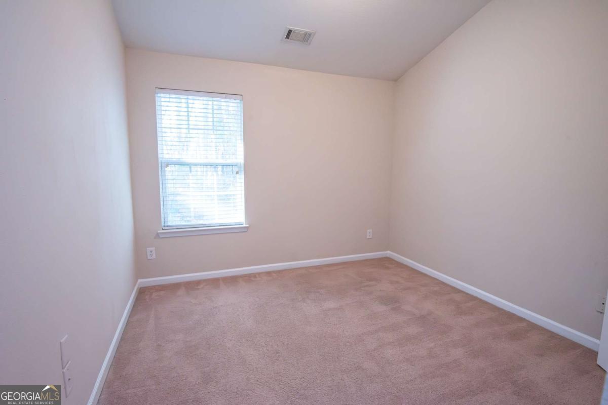 1259 Chinon Point Lithonia, GA 30058 - Photo 23 of 27 an empty room with a window