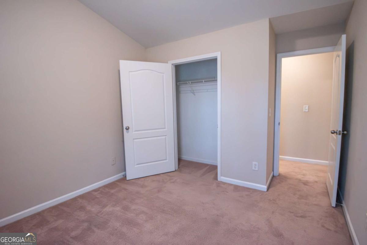 1259 Chinon Point Lithonia, GA 30058 - Photo 24 of 27 an empty room with closet area