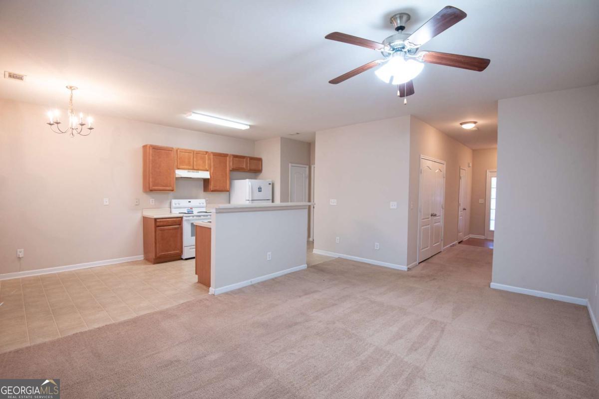 1259 Chinon Point Lithonia, GA 30058 - Photo 4 of 27 a view of a kitchen with a sink and a chandelier fan