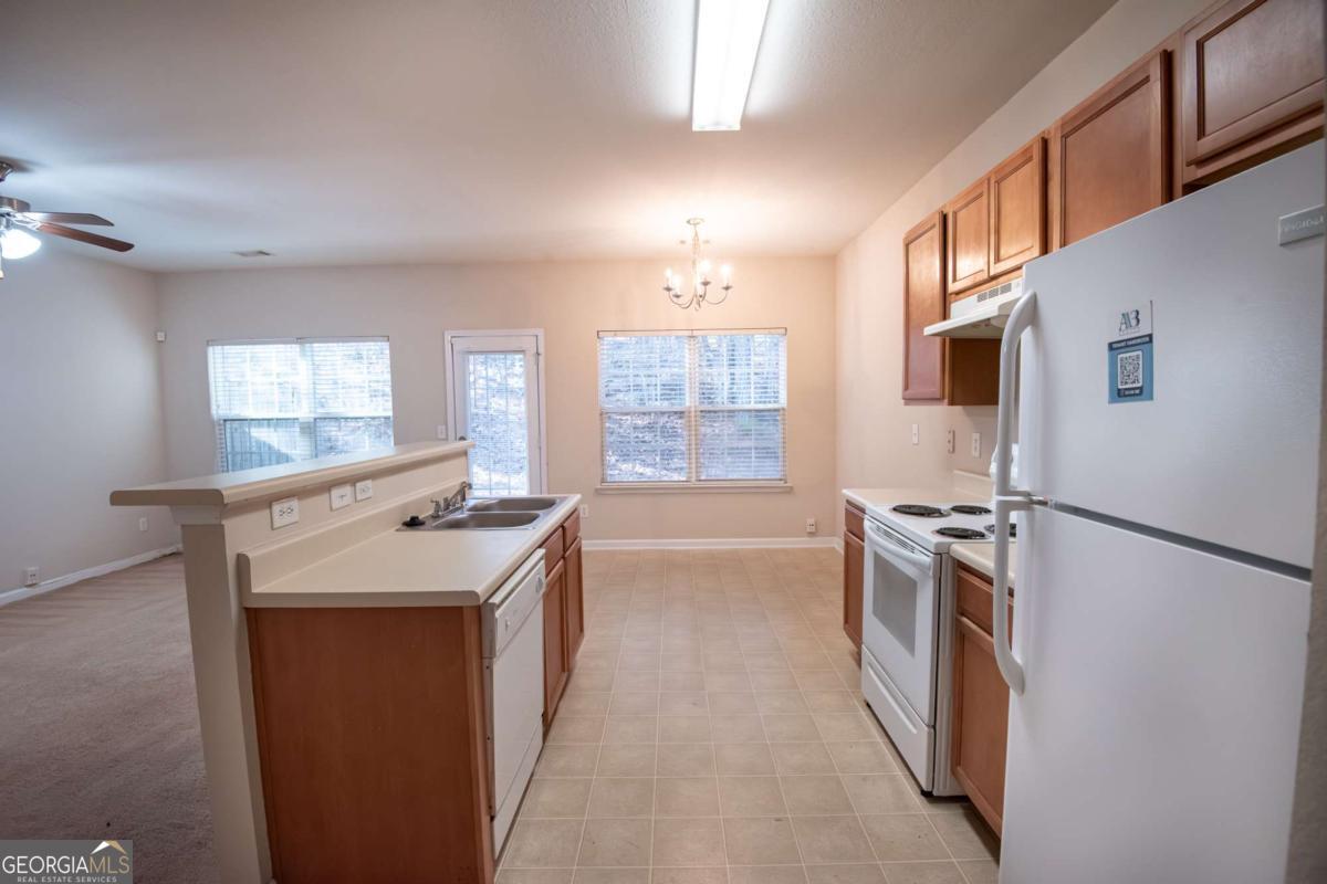 1259 Chinon Point Lithonia, GA 30058 - Photo 6 of 27 a kitchen with a sink stove and refrigerator