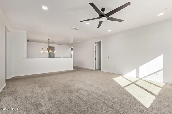 a view of a livingroom with a ceiling fan and wooden floor