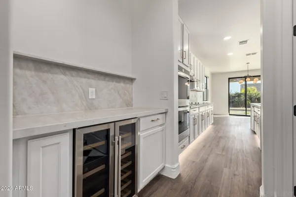 a kitchen with stainless steel appliances a stove and wooden floor