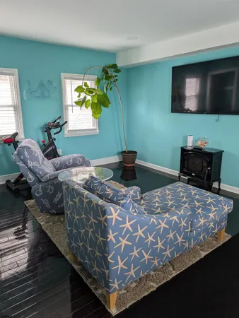 a bedroom with bed and a flat screen tv