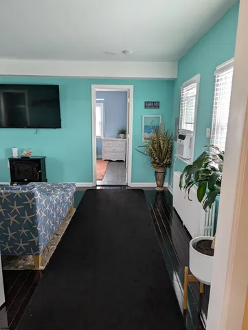 a bedroom with a bed potted plant on the dresser and a potted plant