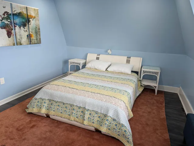 a bed sitting in a bedroom next to a wall